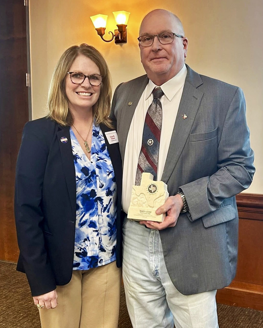 SERVICE TO STATE Susan Redford, Executive Director of the Texas Association of Counties (left) presented award and Floyd County Judge Marty Lucke with an award recognizing his decade of service on the TAC UCF board of directors. | TEXAS ASSOCIATION OF COUNTIES