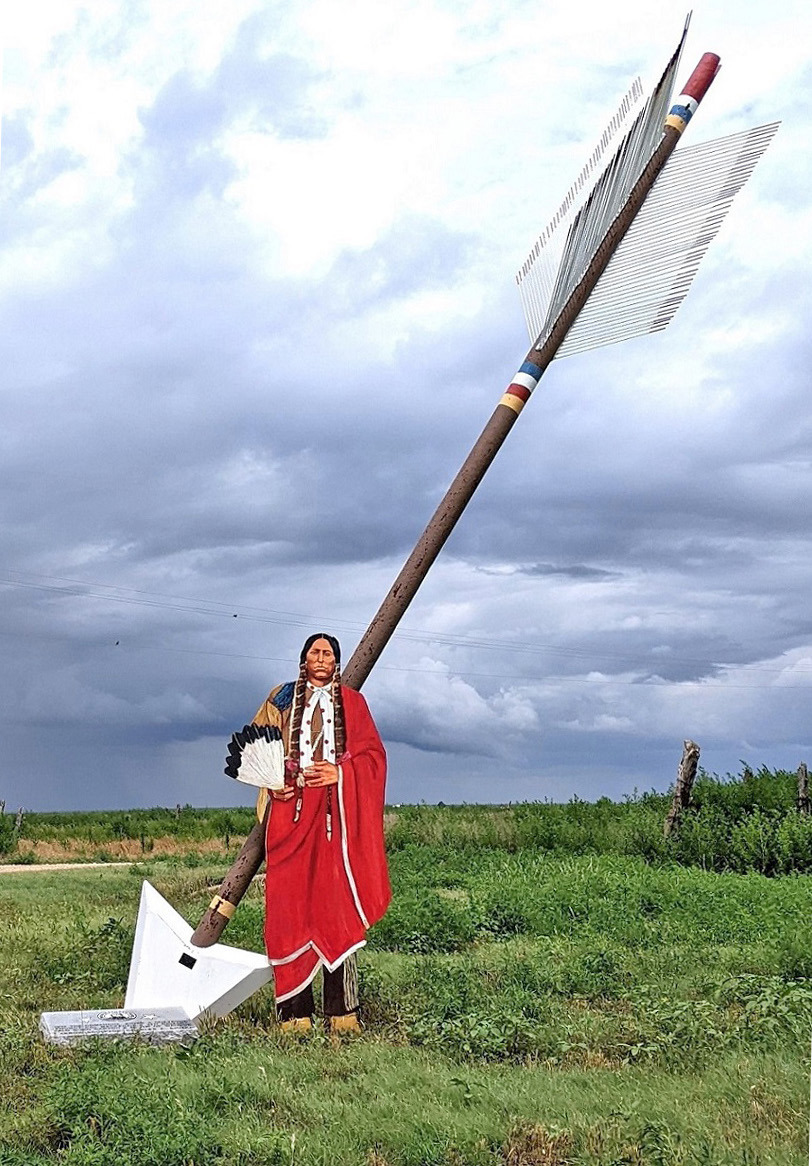 A QUANAH CUTOUT stands next to a Quanah Parker Trail arrow at Wayside, Texas, near to the trail where 150 years ago, on September 28, 1874, in the Battle of Palo Duro Canyon, Col. Ranald S. Mackenzie and the 4th Cavalry descended to the canyon floor and ambushed Comanche, Kiowa and Cheyenne bands seeking refuge there from the converging U.S. forces trying to force them onto reservations —but Quanah with his band of Kwahada were elsewhere. | TEXAS PLAINS TRAIL REGION