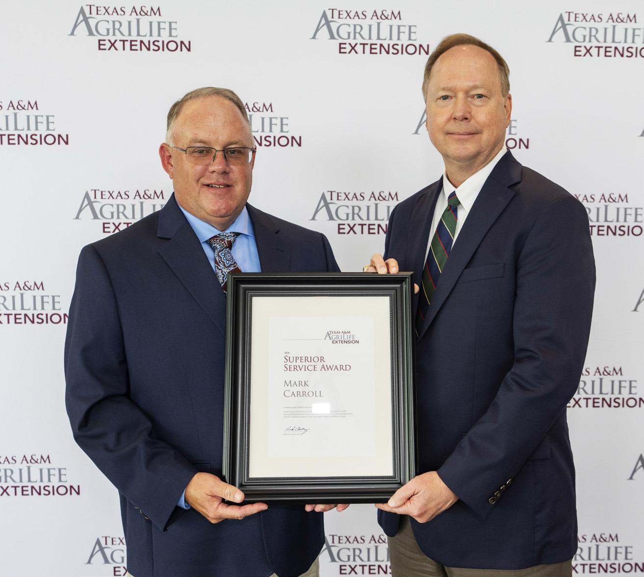 MARK CARROLL (left) recently received County Extension Superior Service Award from Dr. Rick Avery, director of Texas A&amp;M AgriLife Extension Service. | COURTESY PHOTO