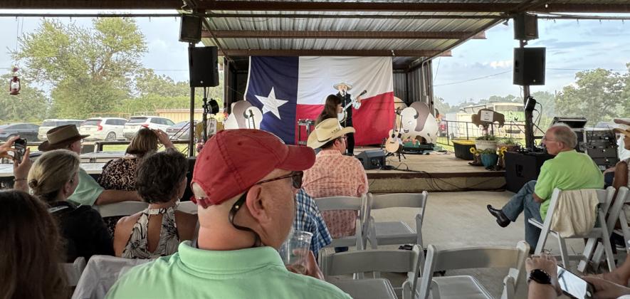 RAINBOW ON THE RANCH Michael Muartin Murphey, featured entertainer at the Texas Press Association dinner June 21, didn’t miss a beat when a rainstorm blew in behind the outdoor stage. | THE TEXAS SPUR