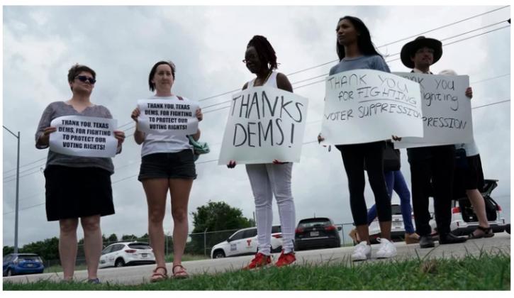 Supporters gather Monday in Austin as Democrats from the Texas Legislature arrive to board a private plane headed for Washington, D.C. The lawmakers fled to try to block action on GOP election bills. Eric Gay/AP