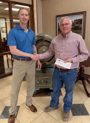 DOLLARS FOR DEPARTMENTS Two area volunteer fire departments, FloydadaVolunteer Fire Department and Dougherty Volunteer Fire Department, each received donations of $5,000 from First Texas National Bank earlier in January. At left, FTNB Senior Vice President Logan Bradley presents a check to Floydada Volunteer Fire Department Chief Chad Guthrie; at right Jim Covington, representing Dougherty Volunteer Fire Department receives a check from Bradley. | COURTESY PHOTOS