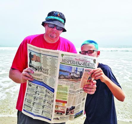BEACH READS Ryan Crowe of Floydada sent this photo of him and son Wesley at the beach in Ventura, California. | CONTRIBUTED PHOTO