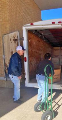 OPERATION CHRISTMAS CHILD shoeboxes collected this year at Floydada’s FBC exceeded all previous years. Volunteers packed up shoeboxes given by donors to be delivered to children all over the world as part of this year’s Operation Christmas Child effort (right). Above, from left, Jerry Leatherman, Moises Reyes and Nathan Adams (inside trailer) worked to pack boxes. | HESPERIAN-BEACON