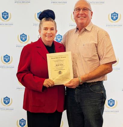 JUDICIAL EDUCATION HONORS Floyd County Judge Marty Lucke (right) was honored recently for his commitment to excellence in service to Texas counties. Comanche County Judge Stephanie Davis, chair of the TAC Judicial Education Committee, presented the award. | TEXAS ASSOCIATION OF COUNTIES