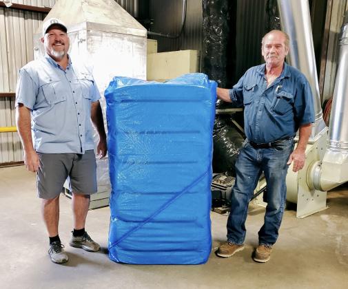 PRODUCER/OWNER IAN McINTOSH brought in the first bale of cotton to be ginned in Floyd County and Floydada. Darty Gin ginned the bale at 12:21 p.m., Monday, Sept. 30. McIntosh (left) is shown with gin manager Les Gary. | PHOTO BY SANDRA CASILLAS