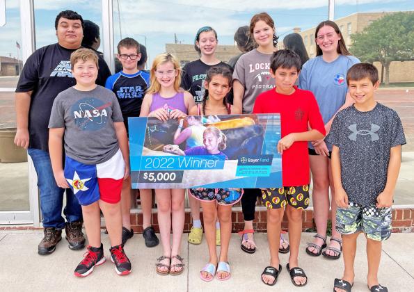 The Floyd County 4-H kids accepting the Bayor grant check are (back row, l-r) Jaime Hernandez, John Taylor Snowden, Mia Snowden, Kaileigh Cook, Sierra Snowden; (front row, l-r) Aaren Rexrode, Ella Snowden, Aphrodite Aguilar, Jaime Guerrero, Braxton Cole. | COURTESY PHOTO