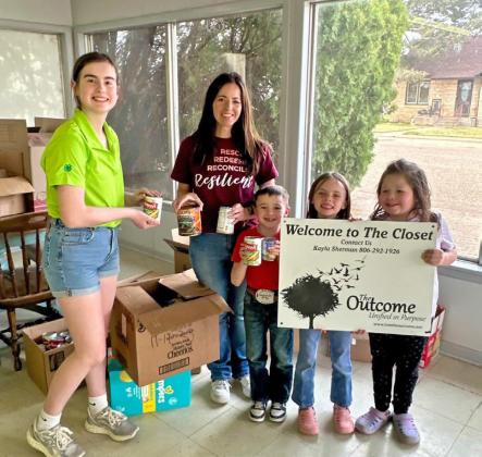 THE OUTCOME Helping out at The Outcome are Ella Snowden (green shirt), Kayla Sherman (maroon shirt), and the children are Thoma, Aubrey and Aspen Sherman. Ella Snowden organized the delivery of donated items to the Outcome Closet. | COURTESY PHOTO