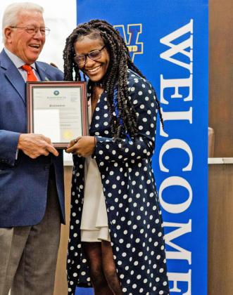“TMS DAY” Plainview mayor Charles Starnes (left) presents Olympic gold medalist Tamyra Mensah-Stock with a copy of a proclamation declaring Feb. 7, 2022 as Tamyra Mensah-Stock Day in the city. | WAYLAND BAPTIST UNIVERSITY / CHRISTINA LONGORIA