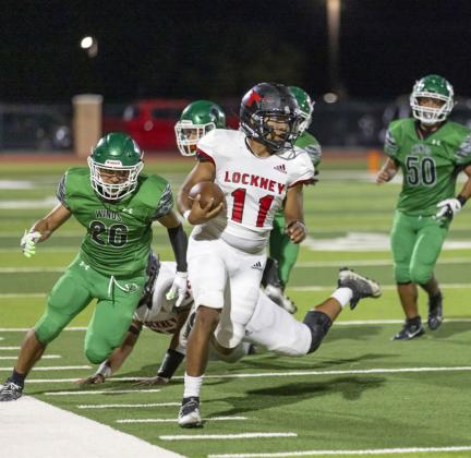PURSUED Longhorn Russell Casillas, #11, evades pursuit by a mighty pack of Whirlwinds. | CERVANTES PHOTOGRAPHY