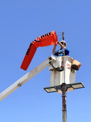 It was time for a new wind sock at the W.J. Mangold hospital helicopter pad last week. Staff expressed thanks to Aerocare for furnishing the sock and to Lighthouse Electric Cooperative (Danny Nixon and Grant Cage) for replacing it on the mounting. | COURTESY PHOTOS