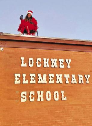 ELF ON THE ROOF? Lockney Elementary got into the holiday spirit earlier this week when they put the principal on the roof to welcome students. See more holiday cheer from Lockney when you read the Santa Letters from Lockney students in Section B. | COURTESY PHOTO