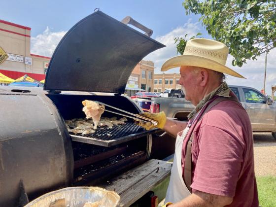 Dickens County volunteer Teary Blasingame cooked and served chicken and sausage Thursday in downtown Matador.