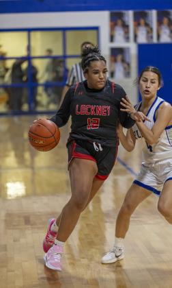 TYLEE BENTON drives past the Olton Fillies Jan. 30.