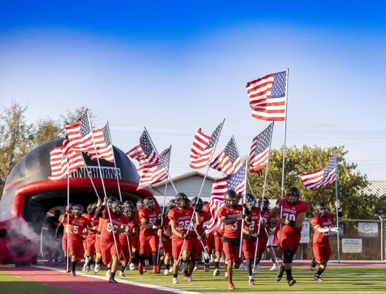 MEMORIAL TRIBUTE The Longhorns entered the field carrying American flags in memory of those who died on 9-11. | CERVANTES PHOTOGRAPHY