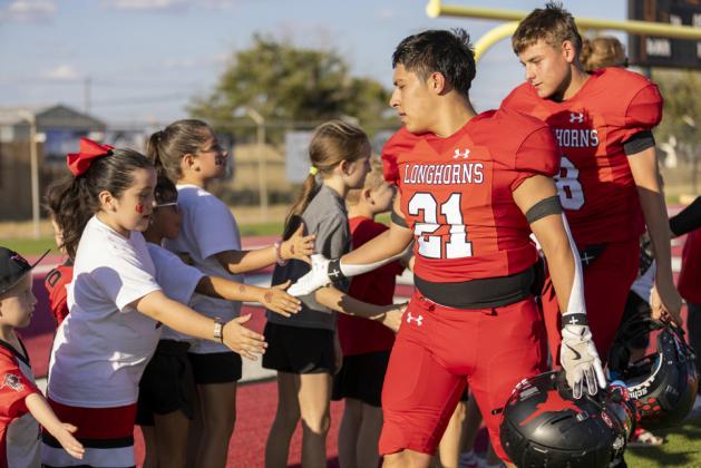 De Los Santos and Logan Rodriguez shaking the Bleacher Creatures hands