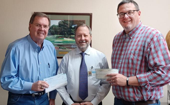 EDCs HELP MANGOLD Brent Baker of the Lockney Economic Development Corporation and his Floydada EDC counterpart Ryan Crowe present W.J. Mangold Memorial Hospital CEO Vince DiFranco with check donations to the Mangold Hospital Foundation toward the purchase of a new Phillips CT machine for the hospital. DiFranco said the foundation had raised $300,000 toward the purchase. Installation of the new machine began on Monday, April 17. | COURTESY PHOTO
