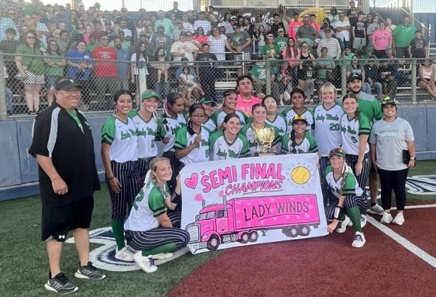 GOLDEN GLOW Members of the Lady Winds softball team hoist the semifinal trophy after taking two games of three against Colorado City May 7. They’ll face Cisco next Saturday for a chance at the State championship. | JOSE CARILLO PHOTO