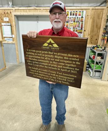STEVE RILEY, general manager of CCFA, shows off the plaque made by Larry Wood of Idalou that will be mounted on the McAdoo store's wall.