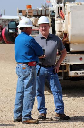 LINEMAN TRAINING Mike Green (right) worked in the field—here, with Dickie Cloyd— before moving into the office. | COURTESY PHOTO