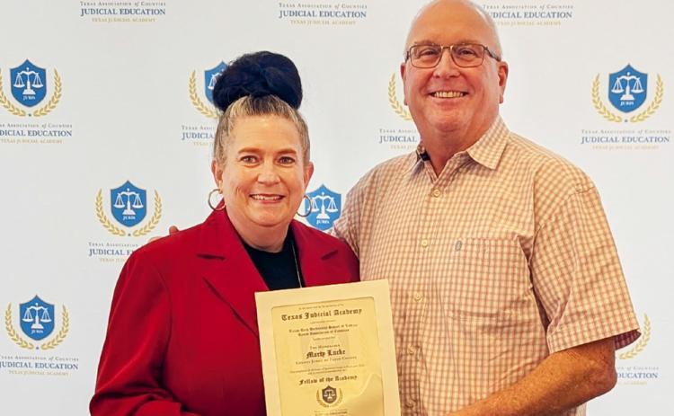 JUDICIAL EDUCATION HONORS Floyd County Judge Marty Lucke (right) was honored recently for his commitment to excellence in service to Texas counties. Comanche County Judge Stephanie Davis, chair of the TAC Judicial Education Committee, presented the award. | TEXAS ASSOCIATION OF COUNTIES
