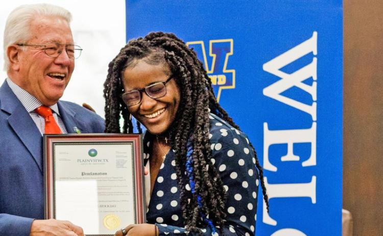 “TMS DAY” Plainview mayor Charles Starnes (left) presents Olympic gold medalist Tamyra Mensah-Stock with a copy of a proclamation declaring Feb. 7, 2022 as Tamyra Mensah-Stock Day in the city. | WAYLAND BAPTIST UNIVERSITY / CHRISTINA LONGORIA