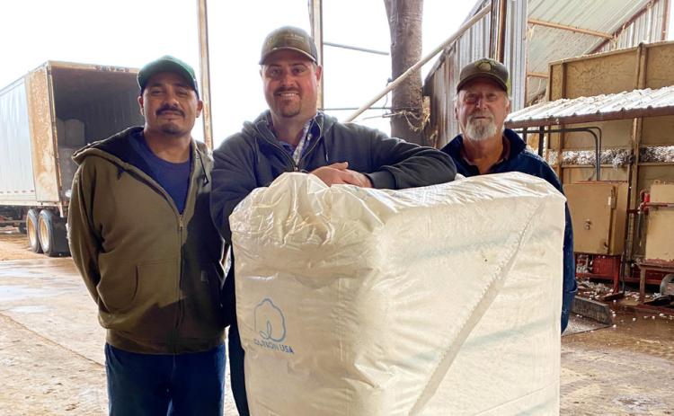 FIRST BALE OF COTTON ginned in Floyd County and Floydada in 2026 was from producer Jacob Reddy. McCoy Gin ginned the bale on Wednesday, Oct. 7. From left are ginner Raul Corado, producer Jacob Reddy and gin manager Andy Rainwater. | COURTESY PHOTO