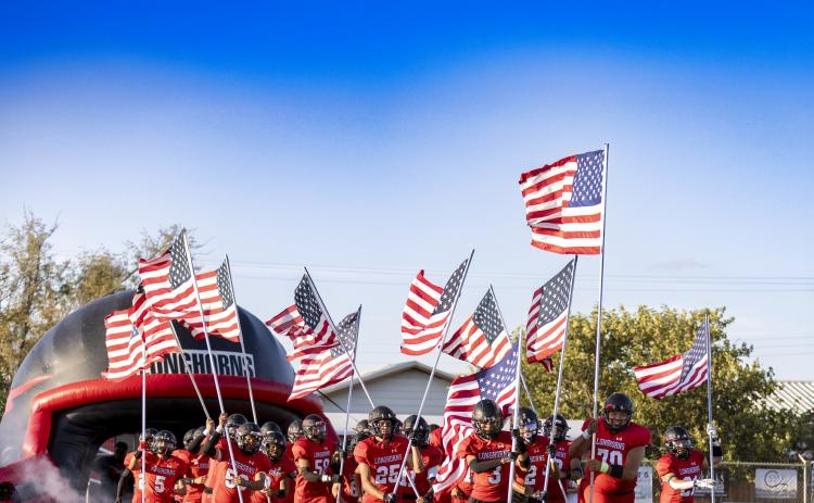 MEMORIAL TRIBUTE The Longhorns entered the field carrying American flags in memory of those who died on 9-11. | CERVANTES PHOTOGRAPHY