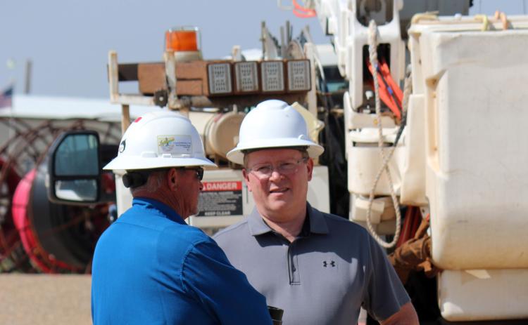 LINEMAN TRAINING Mike Green (right) worked in the field—here, with Dickie Cloyd— before moving into the office. | COURTESY PHOTO